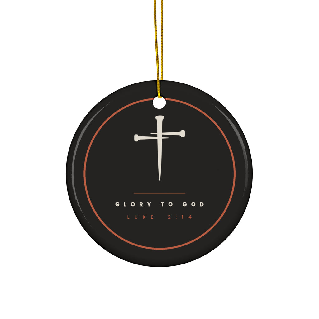 Black ceramic Christmas ornament with cream nail cross and Glory To God, Luke 2:14, inside a copper ring, hanging from a gold string