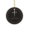 Black ceramic Christmas ornament with cream nail cross and Glory To God, Luke 2:14, inside a copper ring, hanging from a gold string