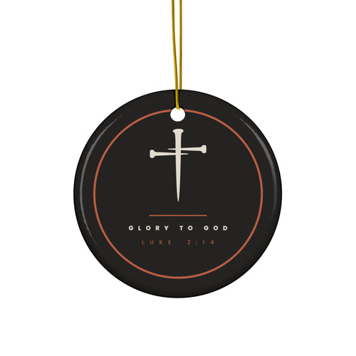 Black ceramic Christmas ornament with cream nail cross and Glory To God, Luke 2:14, inside a copper ring, hanging from a gold string