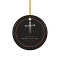 Black ceramic Christmas ornament with cream nail cross and Born This Day, Luke 2:11, inside a copper ring, hanging from a gold string