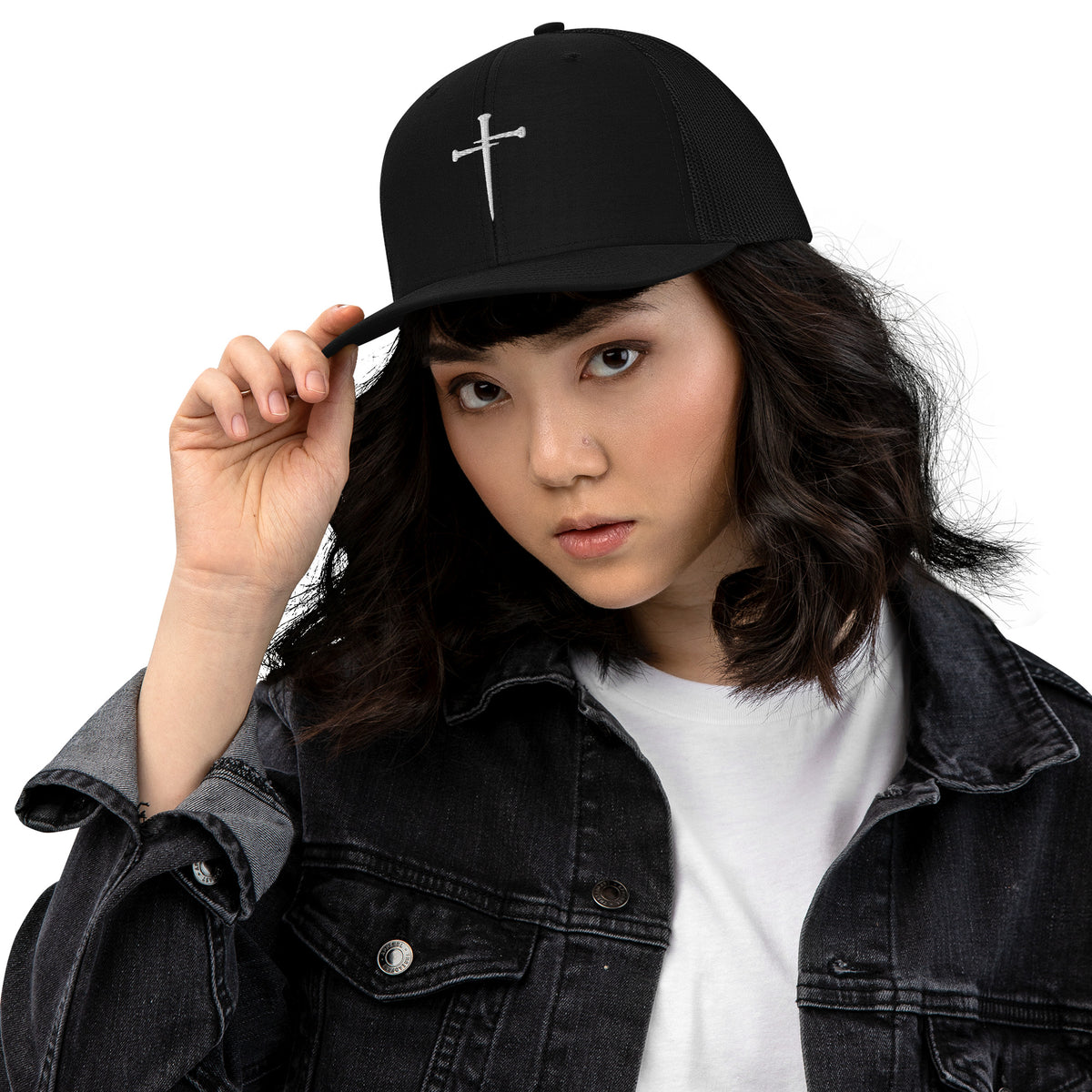Lifestyle shot of the black embroidered trucker cap