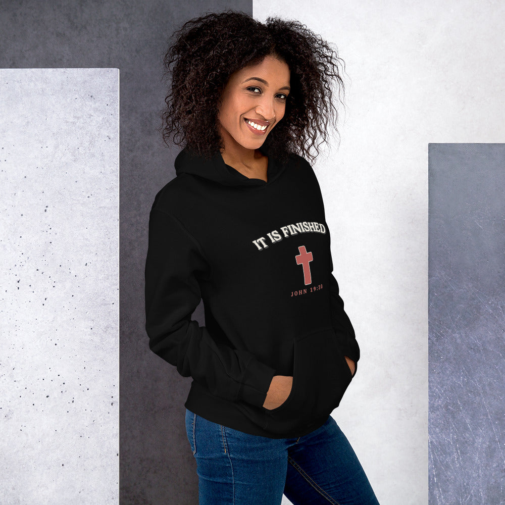 Woman wearing the It Is Finished black hoodie with cream arched lettering and red cross, front view