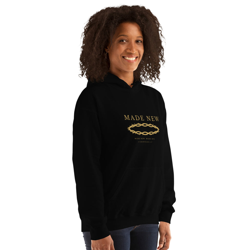Close-up of the Made New gold crown of thorns print on a black hoodie