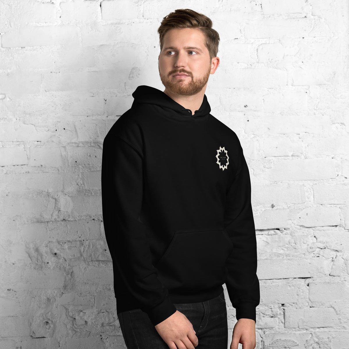 Man wearing the They Meant It As Mockery black hoodie, front view with the crown of thorns on the left chest