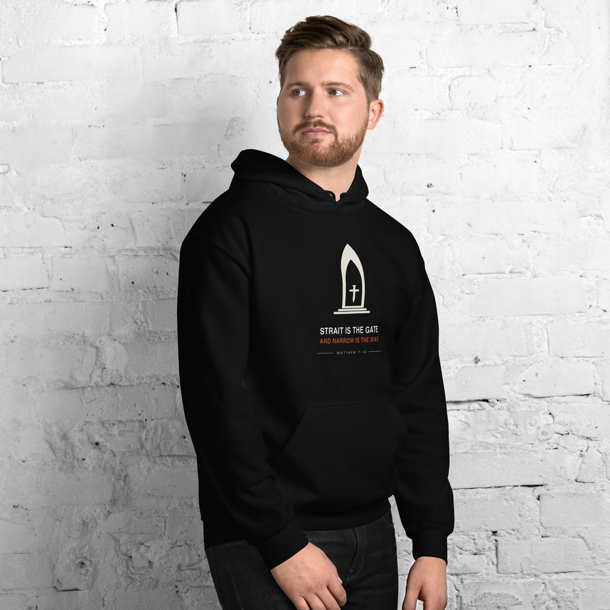Man wearing The Narrow Gate black hoodie with the cream gate and cross chest print, front view