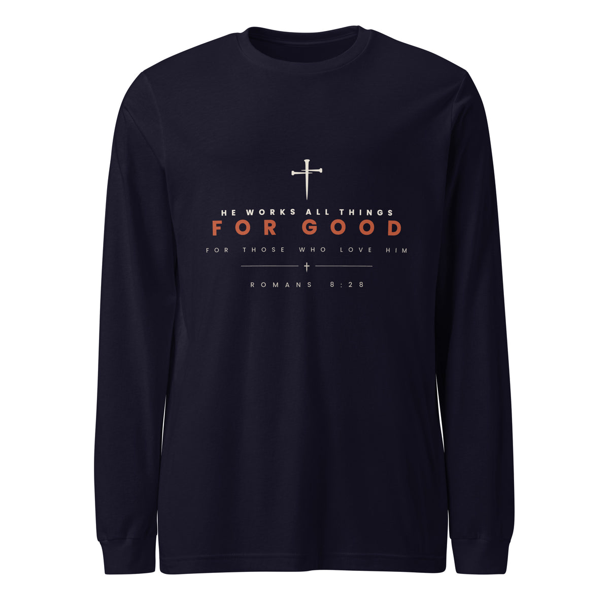 Navy long sleeve tee with a cream cross above HE WORKS ALL THINGS and FOR GOOD in rust, Romans 8:28 beneath