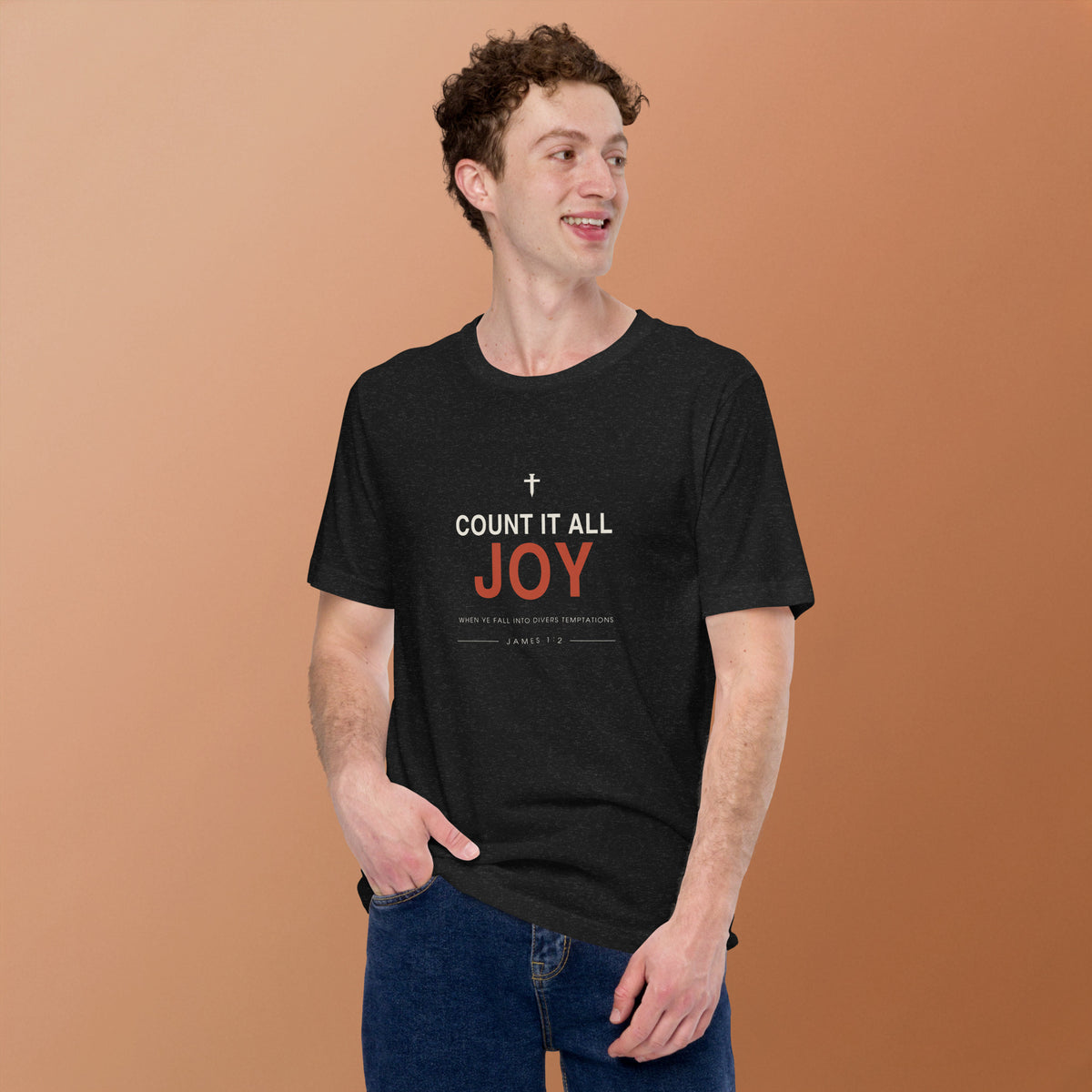 Count It All Joy T-Shirt — model wearing the black heather tee, front view on a warm backdrop