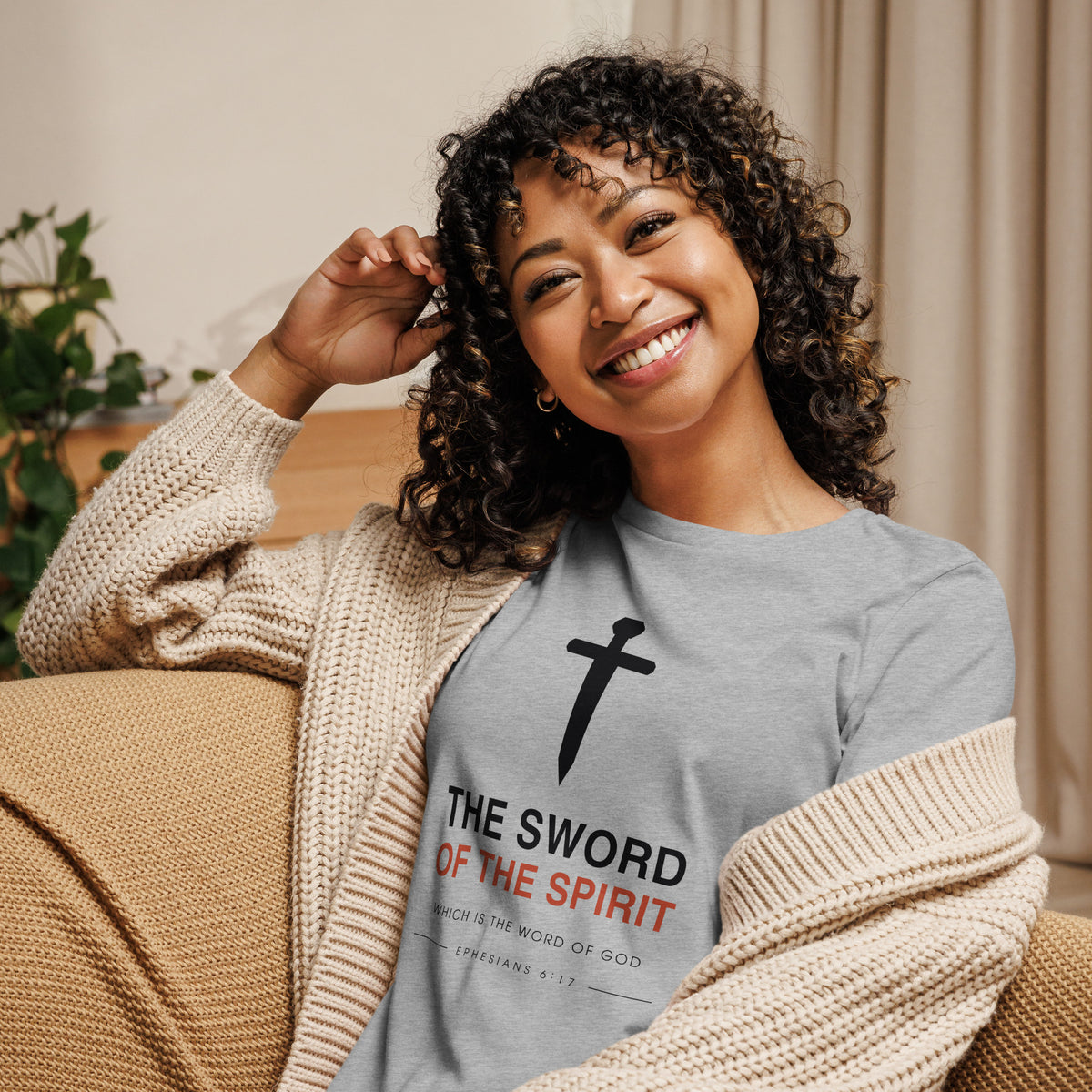 Woman wearing The Sword Of The Spirit Ephesians 6:17 relaxed t-shirt at home, front view